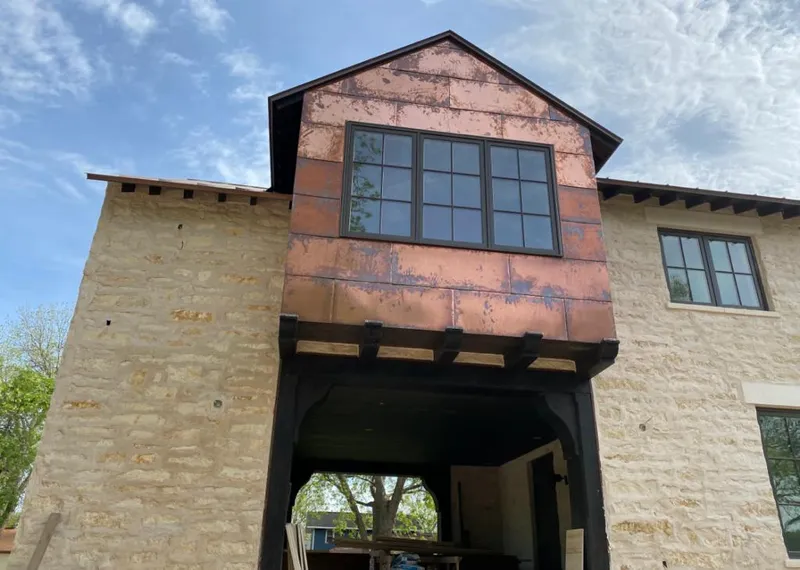 Copper metal panel facade on a stone building for Skylight Installation in Marcellus